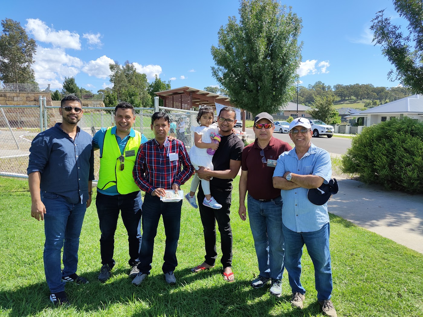 A group of MHCG volunteers standing on the grass