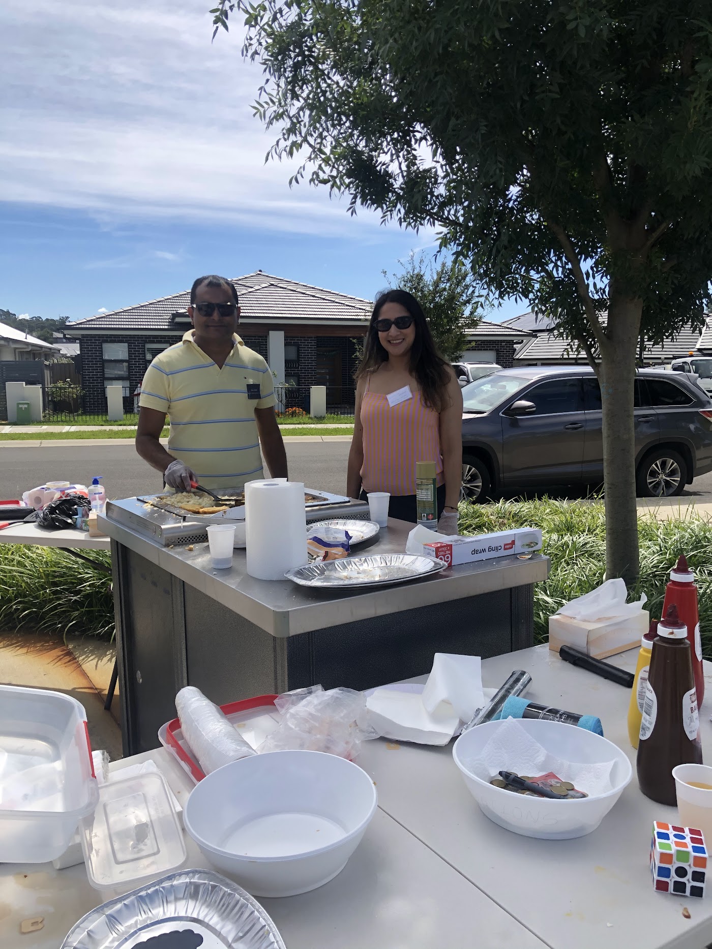 Volunteers serving food from the catering table at the community event