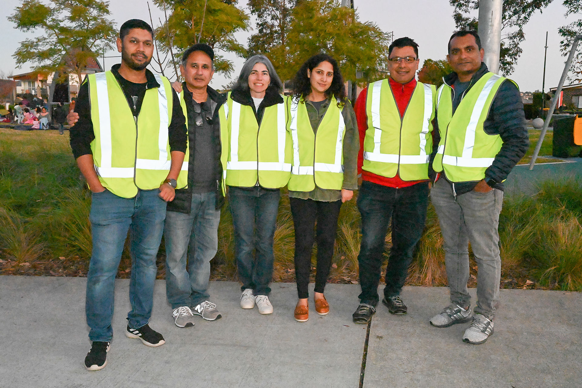 MHCG volunteer team in hi-vis vests standing together in the park
