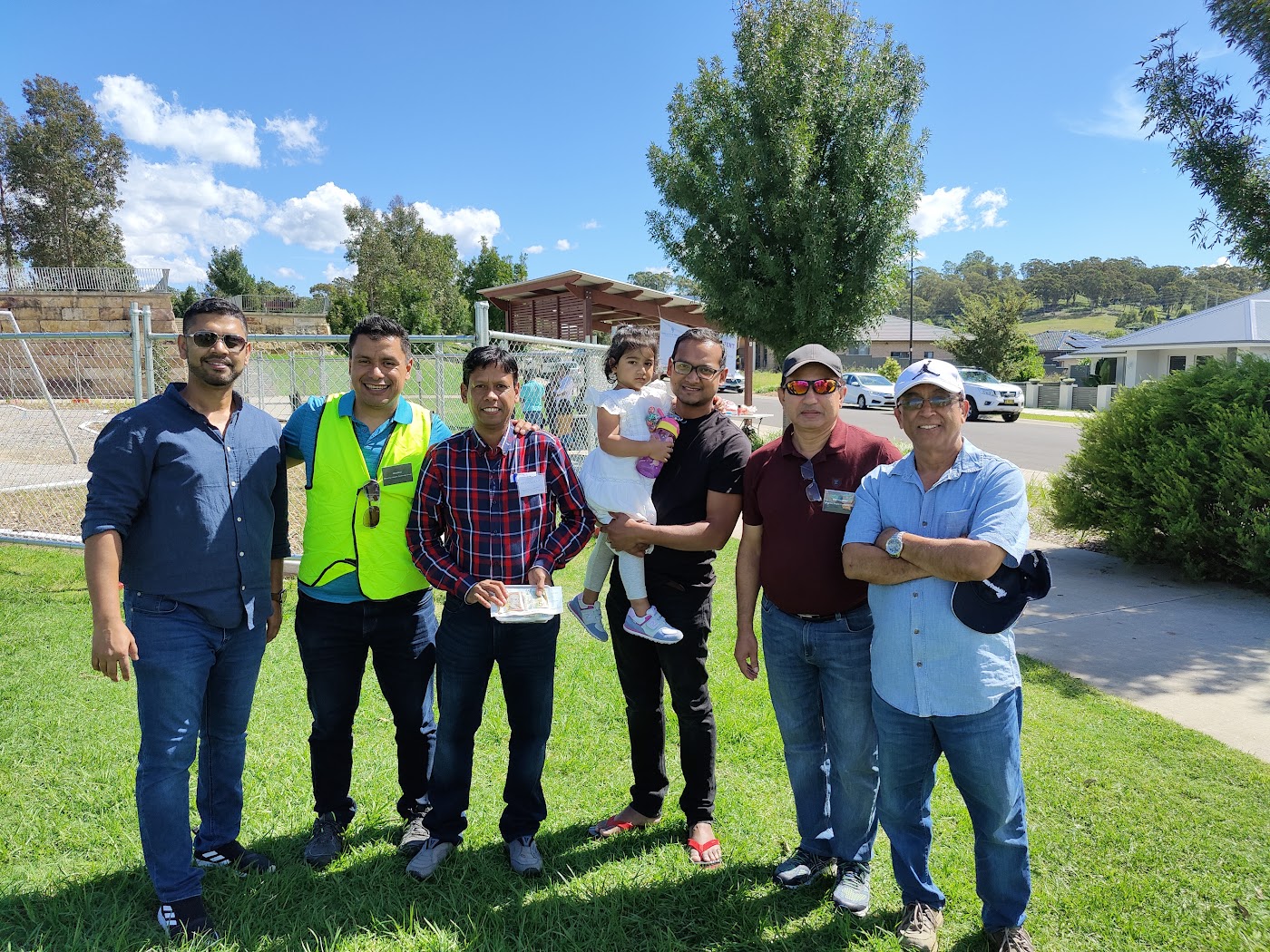 MHCG volunteers in hi-vis vests on a Macarthur Heights street